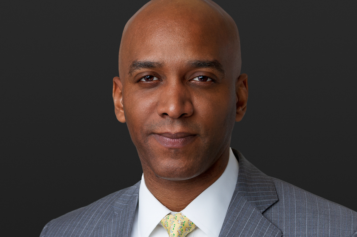 Executive headshot on gray backdrop